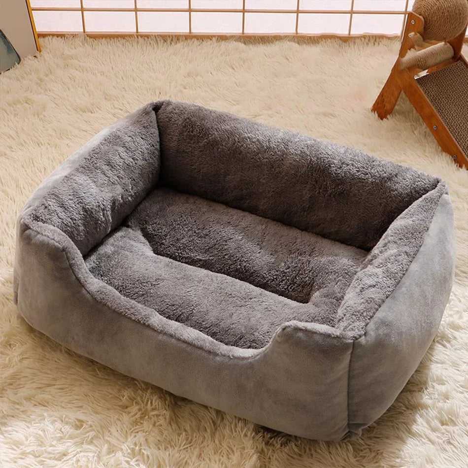 Gray pet bed on a fluffy white carpet