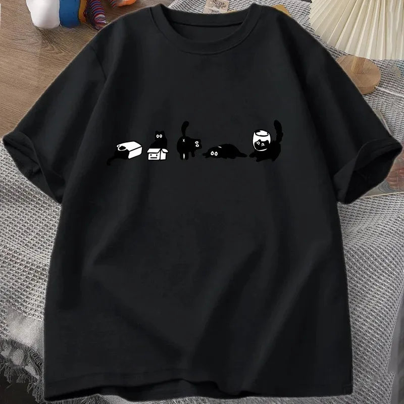 Black t-shirt with cartoon cat illustrations on a textured surface