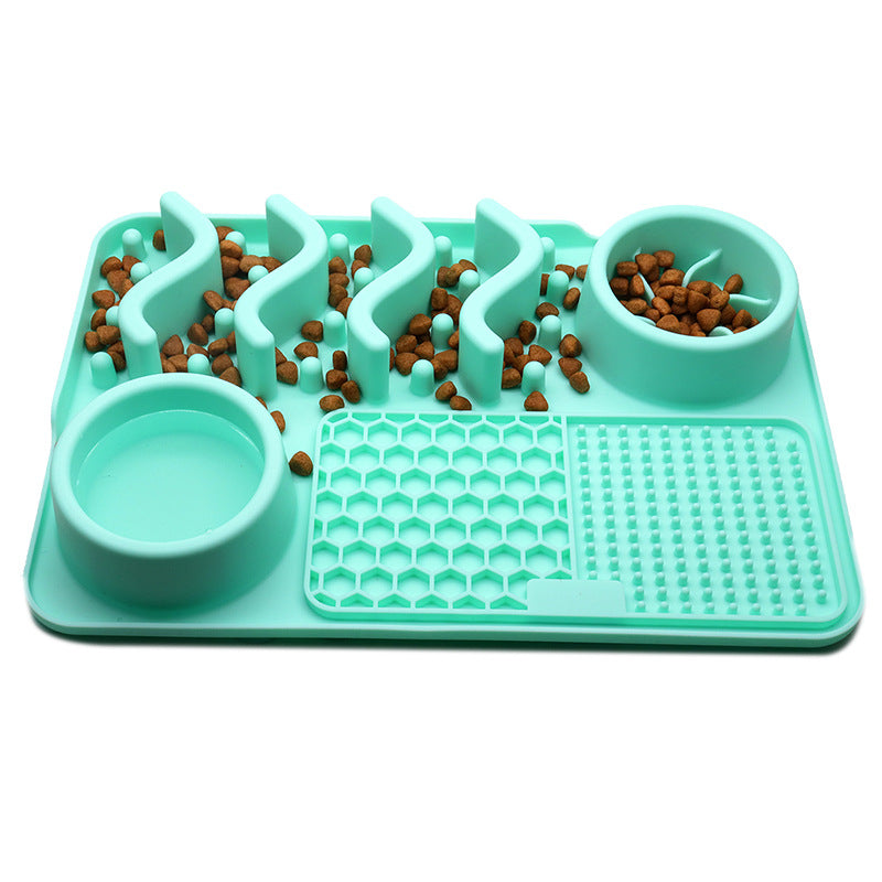 Turquoise pet feeding mat with two bowls and scattered kibble on a white background
