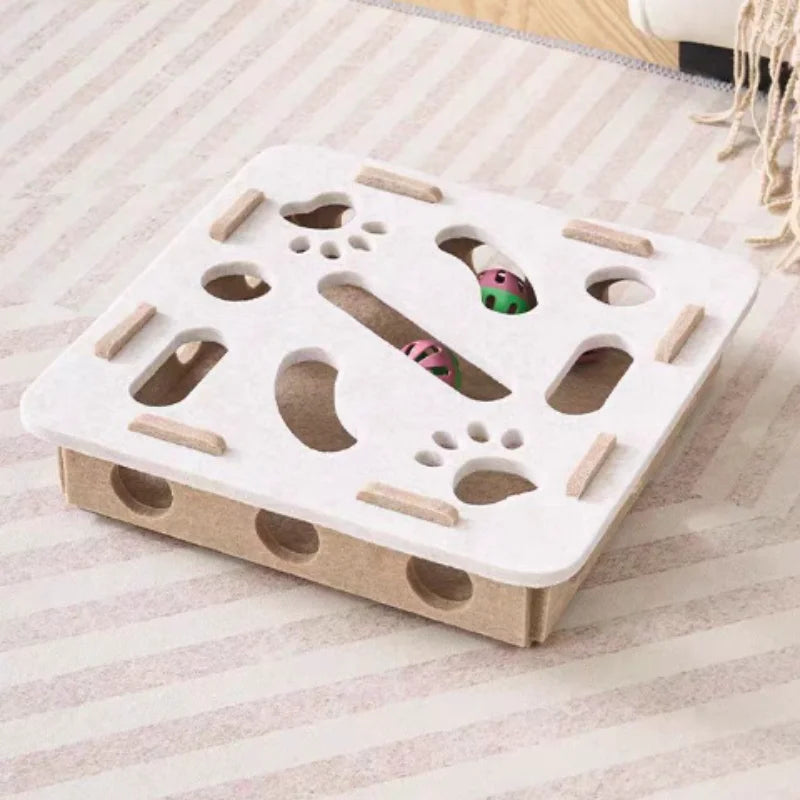 Cat toy with wooden pieces and a small ball on a striped surface