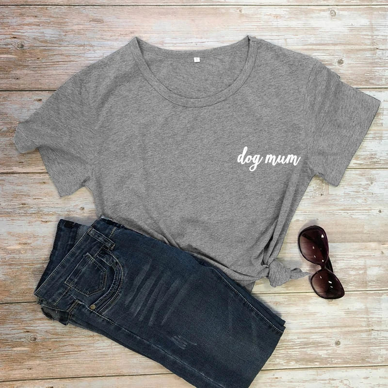 Gray t-shirt with 'dog mum' text, dark jeans, and sunglasses on a wooden surface