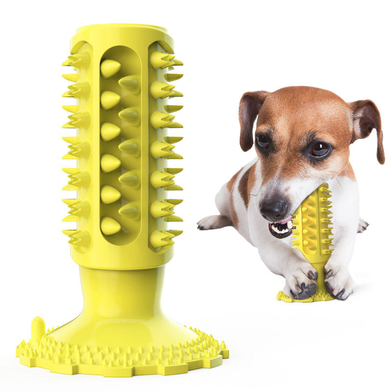 Yellow dog toy with spikes next to a dog on a white background