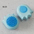 Two blue silicone pet grooming tools on a gray surface