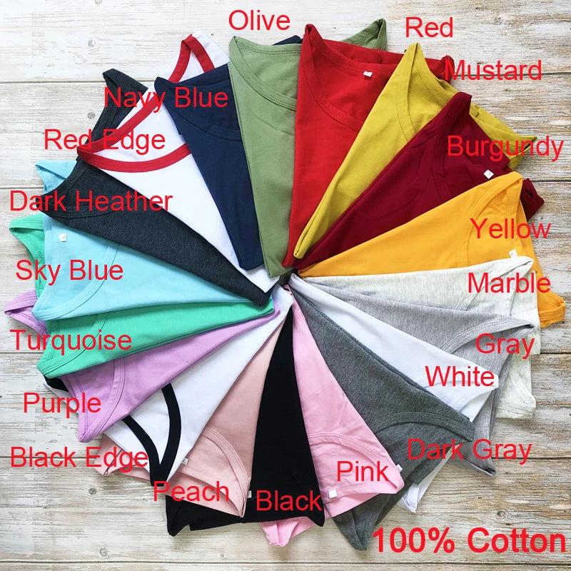 Collection of colorful t-shirts arranged in a circular pattern on a wooden surface with color labels.