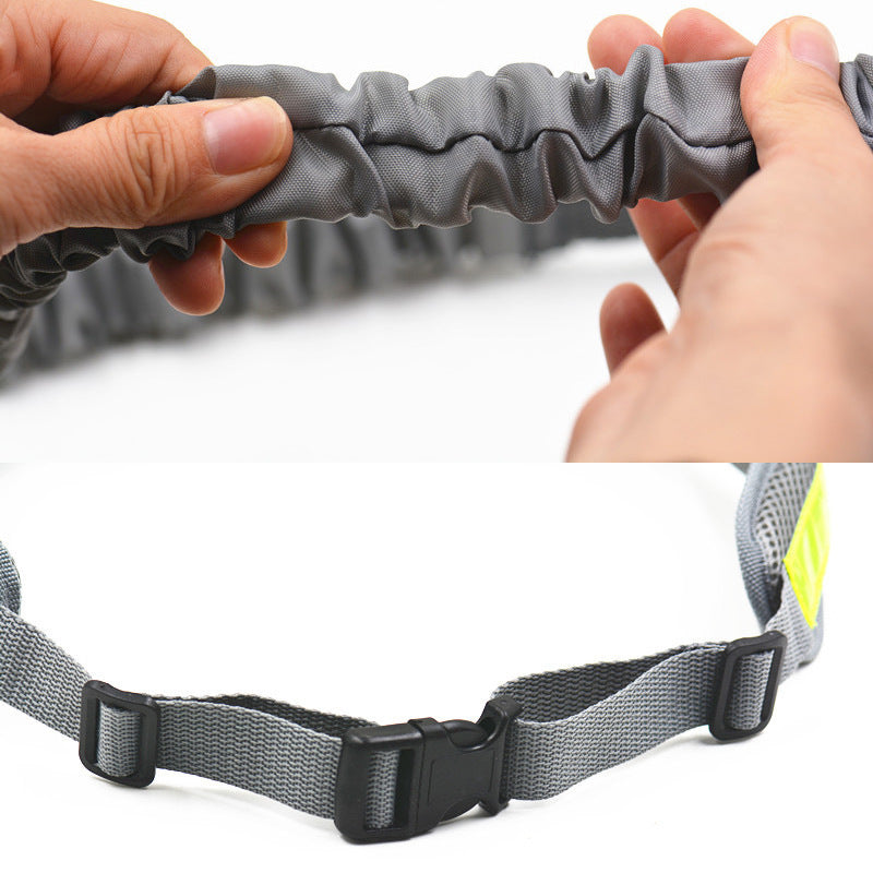 Gray dog leash with a black buckle held by two hands on a white background