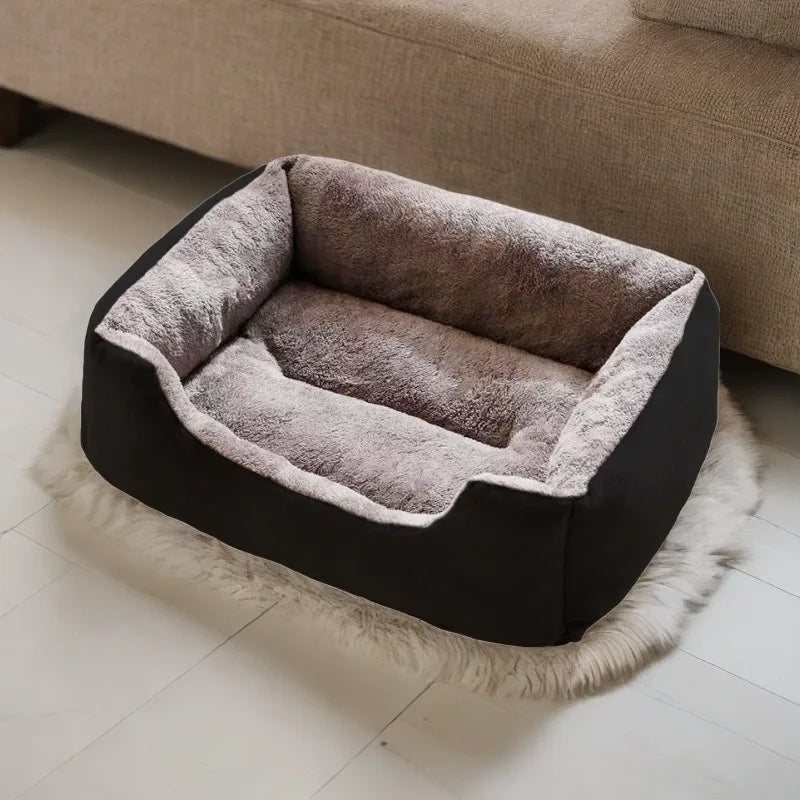 Pet bed with plush interior and black exterior on a light wooden floor.