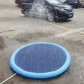 Blue inflatable pool being used to spray water on a car in a parking lot.