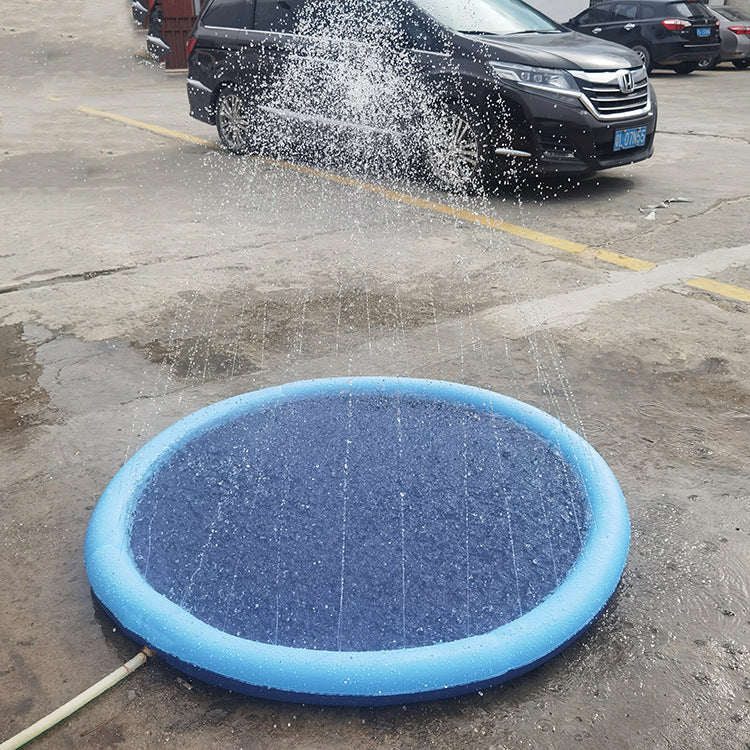 Blue inflatable pool being used to spray water on a car in a parking lot.