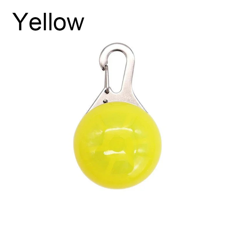 Yellow round object with a metal clip on a white background
