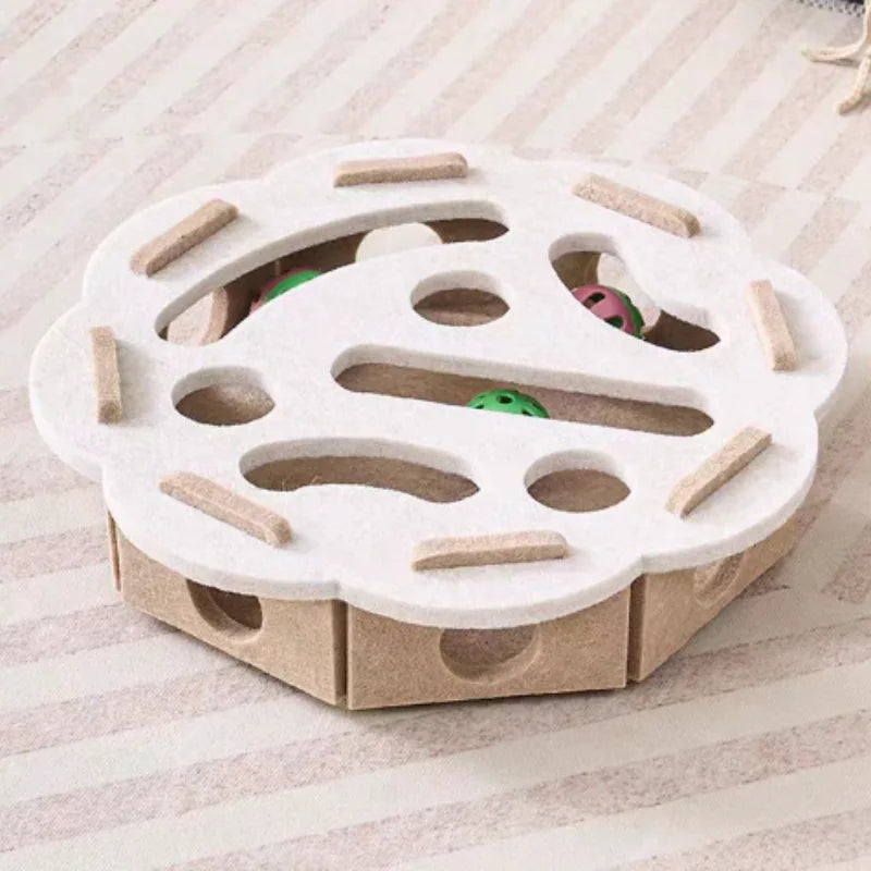Wooden toy with a white top and brown base on a light fabric background