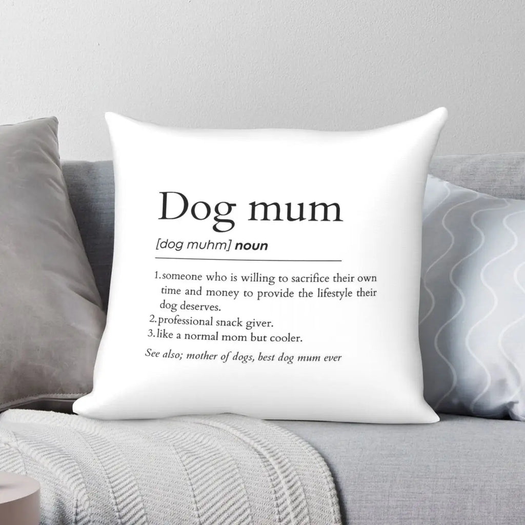 White pillow with text definition of 'Dog mum' on a gray couch.