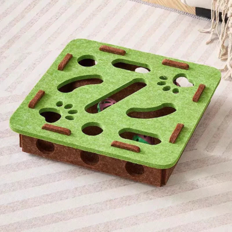 Green and brown puzzle toy for small animals on a light background