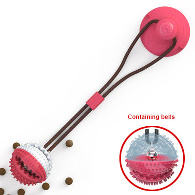 Pink dog toy with a handle and embedded balls on a white background