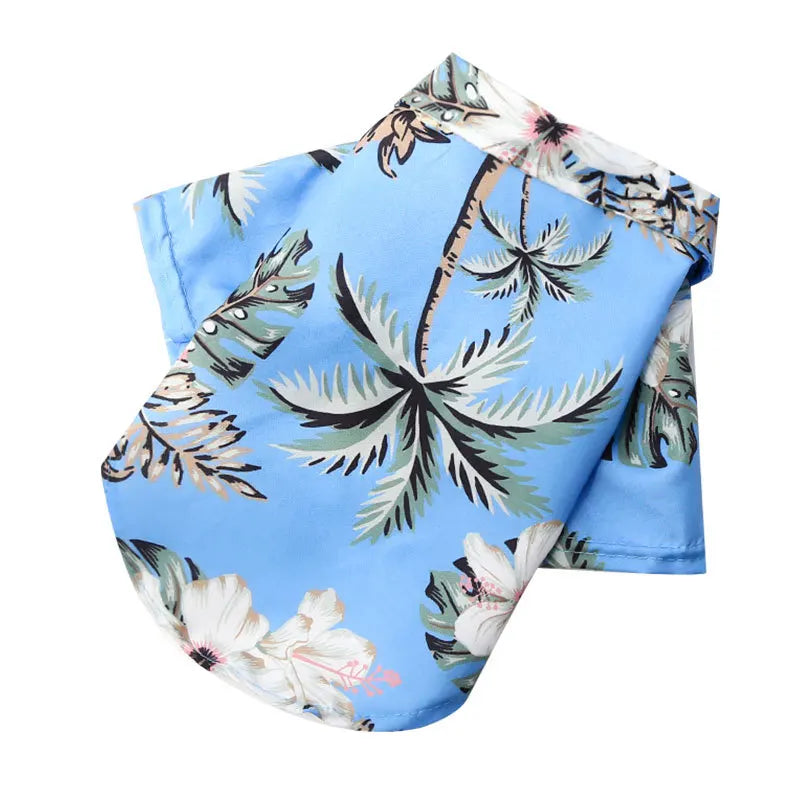 Tropical-themed fabric with palm trees and flowers on a blue background
