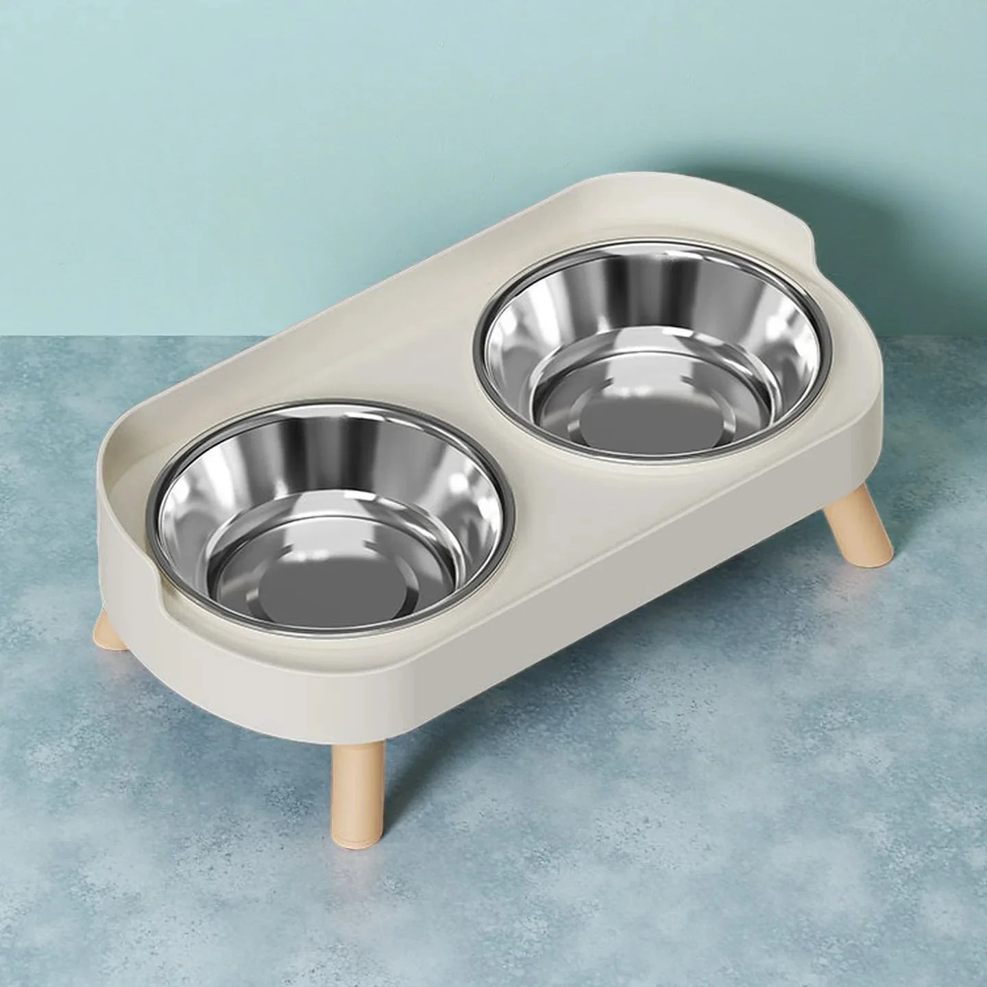 Double pet bowl stand with stainless steel bowls on a light blue background