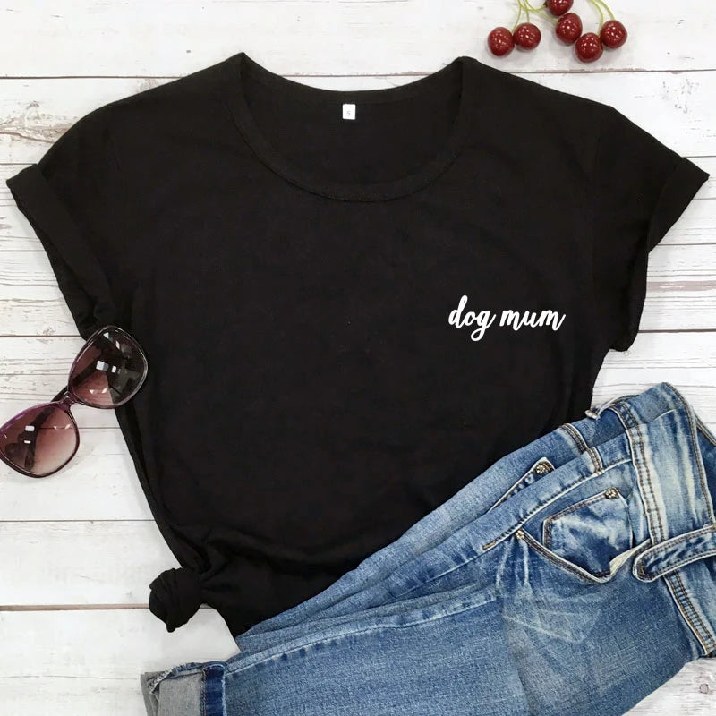 Black t-shirt with 'dog mum' text on a wooden surface with jeans and sunglasses.