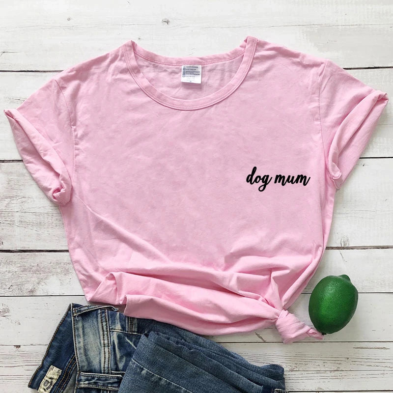 Pink t-shirt with 'dog mum' text on a wooden surface with jeans and a lime.