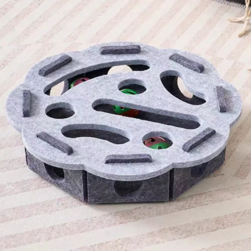 Hexagonal pet toy with multiple holes on a light wooden surface