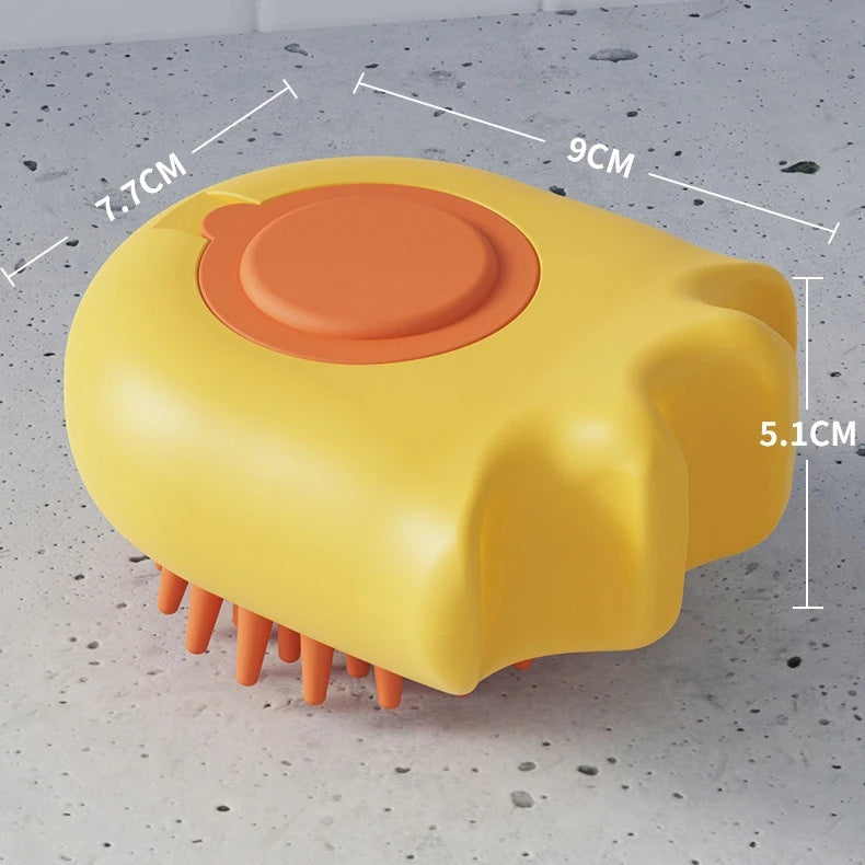 Yellow and orange scalp massager with measurements on a gray surface