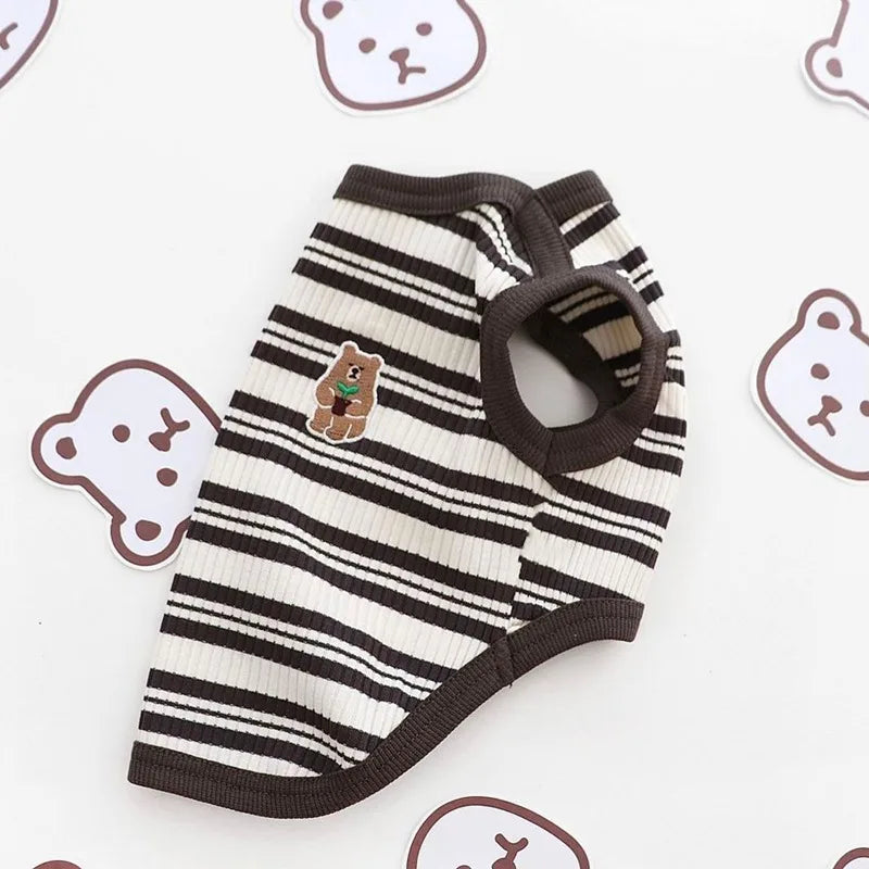 Striped pet dress with bear design on a white background