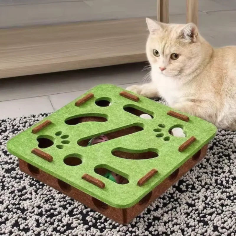 Cat playing with a green and brown puzzle toy on a carpeted floor.