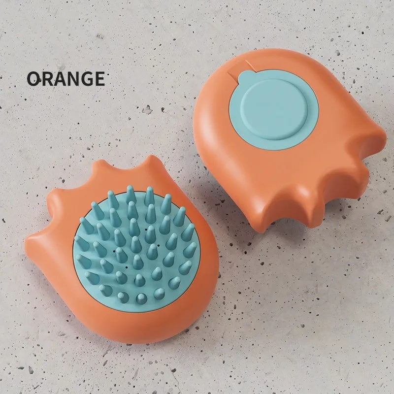 Two orange and teal pet grooming tools on a textured surface with 'ORANGE' text.