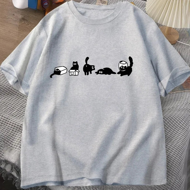 Gray t-shirt with black cat illustrations on a textured surface