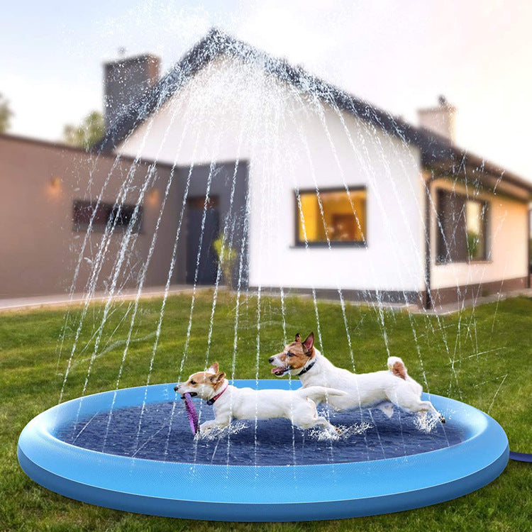 Two dogs playing in a blue inflatable sprinkler pad in a backyard.