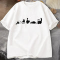 White t-shirt with black cat illustrations on a textured surface