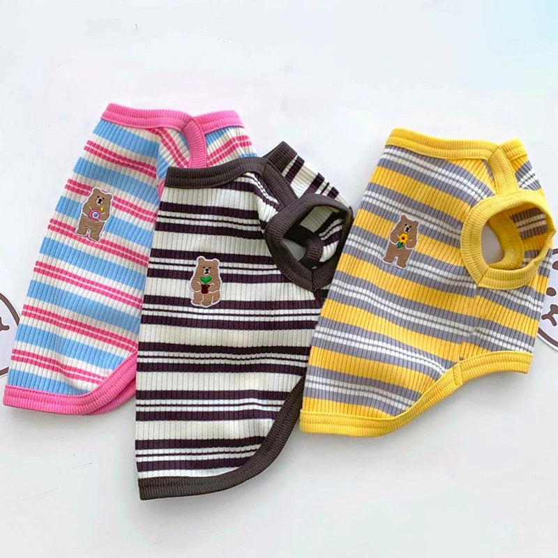 Three colorful striped dog sweaters on a white background