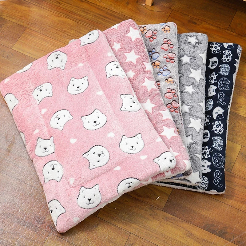 Set of plush blankets with various patterns on a wooden floor