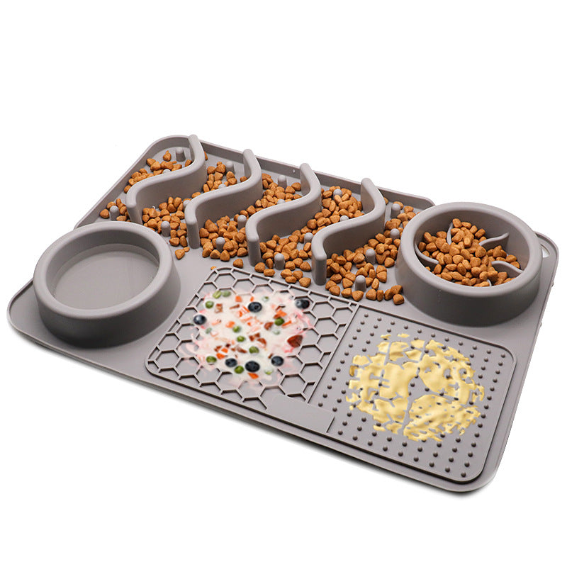 Pet feeding mat with compartments filled with food on a white background