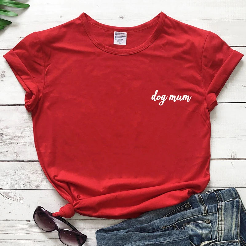 Red t-shirt with 'dog mum' text on a wooden surface with sunglasses and jeans.