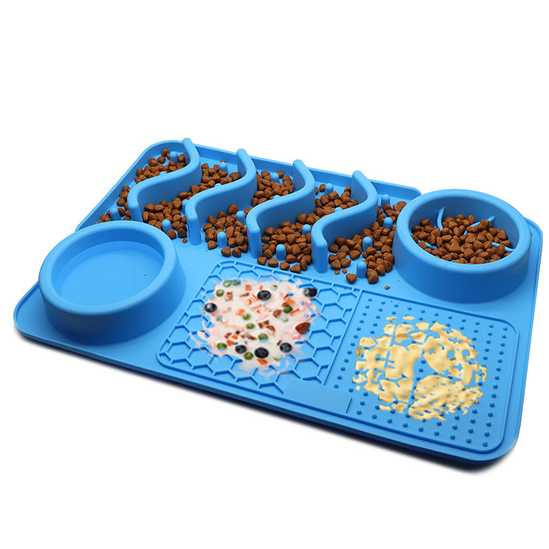 Blue puzzle feeder with compartments filled with dog food on a white background